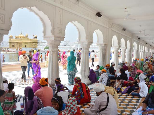 Devotees resting at corridors of the Golden Temple as they come to pay obeisance during hot day in Amritsar on Sunday. Sameer Sehgal/HT