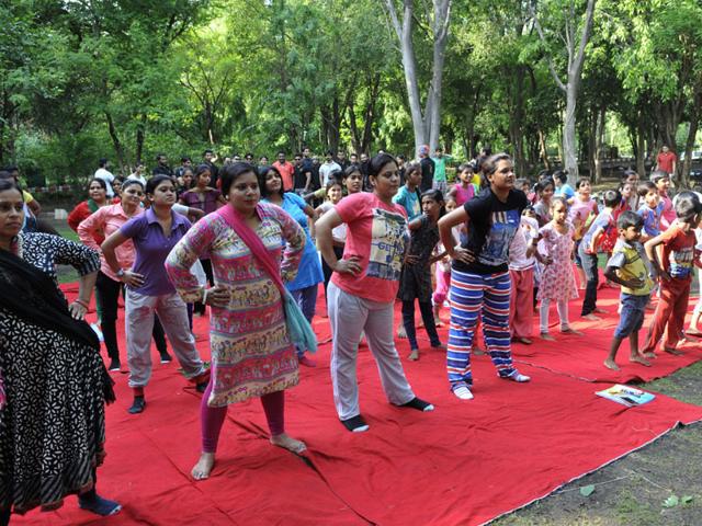 A group of women and children perform Yoga at Ekant Park in Bhopal on Sunday. (Praveen Bajpai/HT photo)