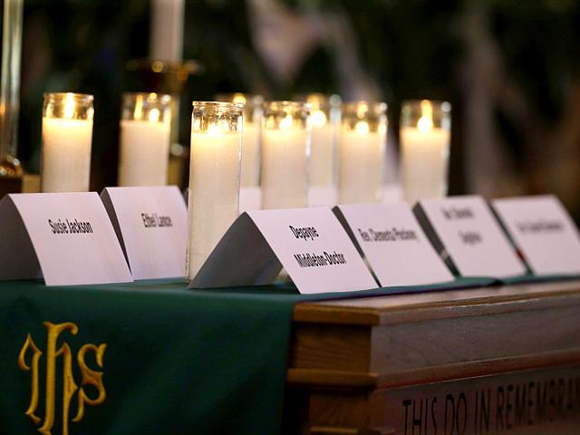 Candles burn for the nine people who were killed at Emmanuel AME Church in Charleston, SC, last Wednesday, during a service at St. Matthew African Methodist Episcopal Church. (AP Photo)