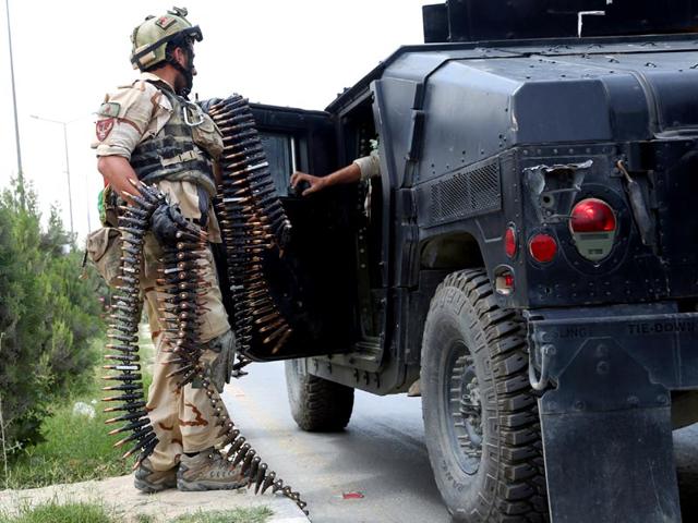 An Afghan soldier loads a military vehicle at the site of the suicide attack. (AP Photo)