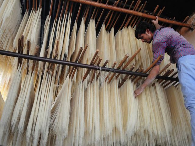 A worker engaged in making vermicelli at a factory in Bhopal. Sweet vermicelli is a traditional Muslim dish consumed during month of Ramzan. (Mujeeb Faruqui/HT)