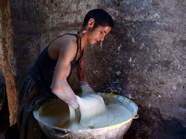 An Afghan labourer works at a traditional 'jelabi' factory in Herat province. (AFP PHOTO)