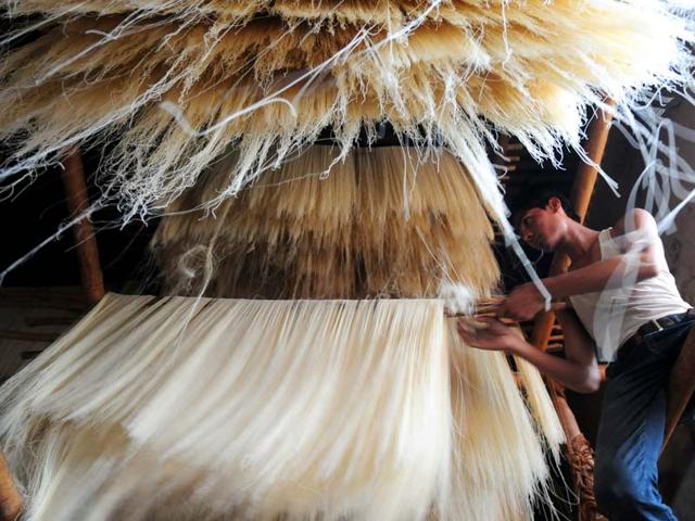A worker arranging 'Sewaiyan' or vermicelli on the floor for 'drying' in Bhopal (Mujeeb faruqui/Hindustan Times)