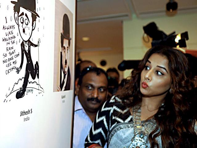 Vidya Balan impressed with a portrait at the exhibition "Chaplin Lines" to honour the legendary actor, Charlie Chaplin in Mumbai on June 25, 2015. (AFP Photo)