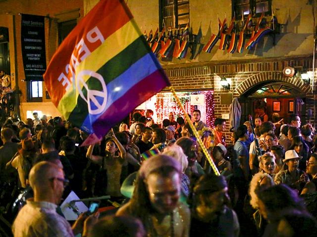 People celebrate outside the Stonewall Inn, late in the night in the Greenwich Village neighborhood of New York. With the SC ruling, gay marriage will become legal in all 50 US states. (Reuters)
