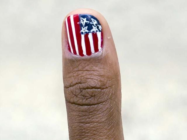 A pattern in the design of the US flag is seen on a girl's fingernail as people are all geared to celebrate the fourth of July. (Reuters Photo)