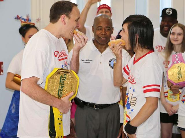 US celebrates its freedom with backyard barbecues and picnics in the park—tables piled high with burgers, frankfurters, potato salad and apple pie— the hot dog eating festival is part of the customary celebrations. (AP Photo)