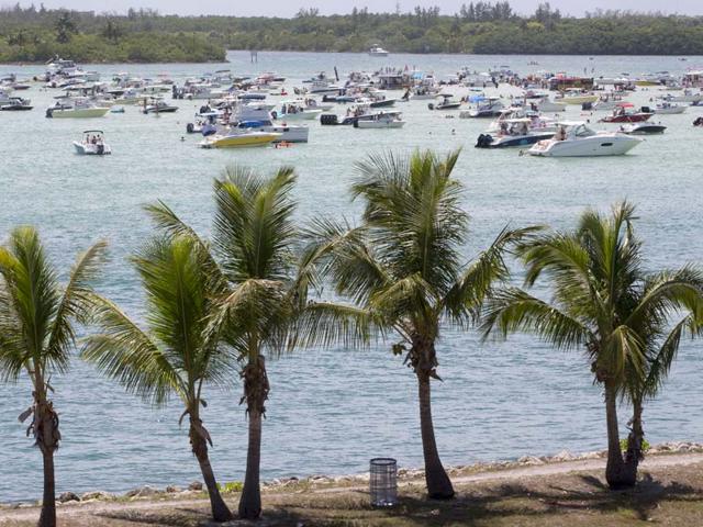 Hundreds of boaters gather near a sand bar in a beach park as they enjoy an early start to the Fourth of July weekend. (AP Photo)
