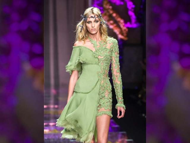 Muted colours are complimented with sequins and bling as models walked on the glass ramp over freshly cut orchids. (AFP Photo/ Miguel Medina)