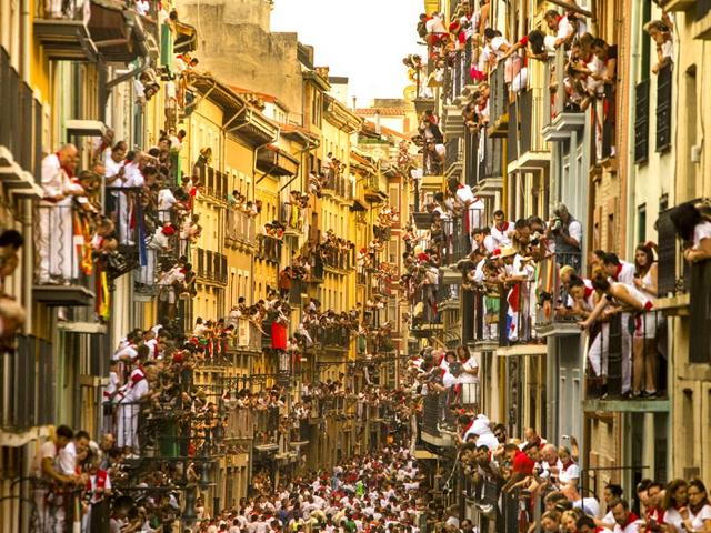 People watch as revelers run in front of Jandilla bulls at the San Fermin festival, in Pamplona, Spain. (AP Photo/Andres Kudacki) People watch as revelers run in front of Jandilla bulls at the San Fermin festival, in Pamplona, Spain. (AP Photo/Andres Kudacki)