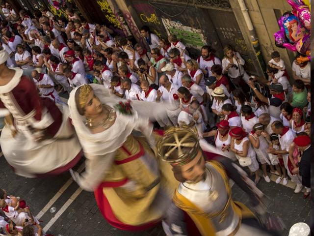 The Giant Parade passing down a street, at the San Fermin Festival. (AP Photo/Alvaro Barrientos) The Giant Parade passing down a street, at the San Fermin Festival. (AP Photo/Alvaro Barrientos)
