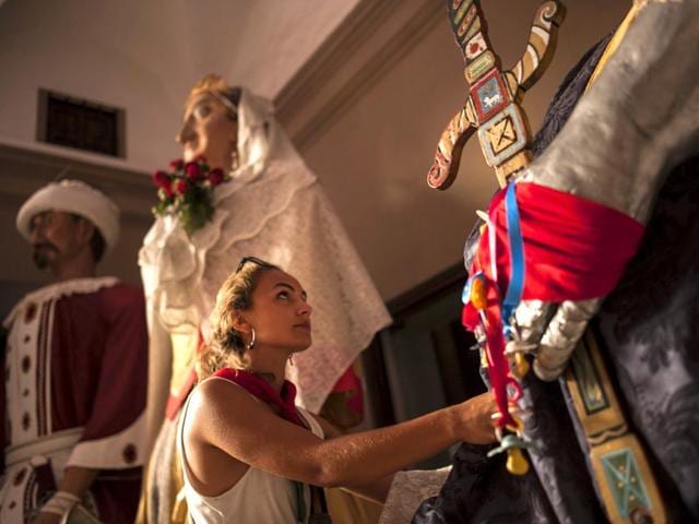 A San Fermin Comparsa Giant Parade member touches one of the Giants at the San Fermin Festival, in Pamplona, Spain, Tuesday, July 7, 2015. Every year, people from around the world come to Pamplona to participate in the eight-day festival of running of the bulls. (AP Photo/Alvaro Barrientos) A San Fermin Comparsa Giant Parade member touches one of the Giants at the San Fermin Festival, in Pamplona, Spain, Tuesday, July 7, 2015. Every year, people from around the world come to Pamplona to participate in the eight-day festival of running of the bulls. (AP Photo/Alvaro Barrientos)