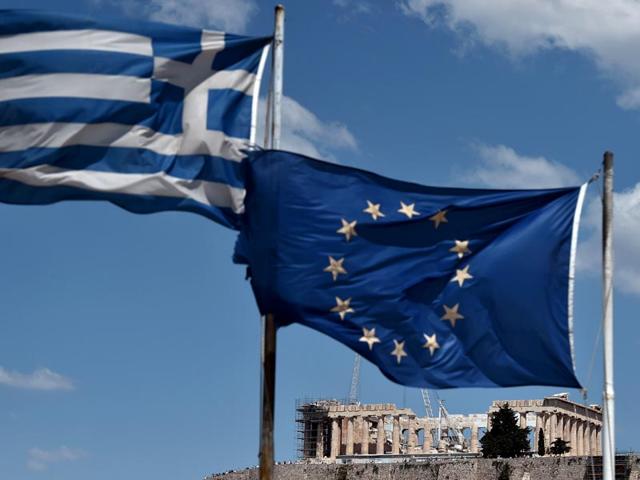 EU-and-Greek-flag-wave-in-front-of-the-ancient-temple-of-Parthenon-in-Athens-AFP-Photo