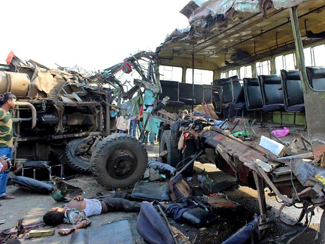 Bystanders-and-police-personal-gather-at-the-site-of-a-road-accident-in-which-a-private-passenger-bus-and-a-lorry-collided-on-the-National-Highway-34-in-the-Malda-district-about-340-kms-north-of-Kolkata-on-March-27-2014-Seven-people-were-killed-and-thirty-others-injured-in-the-head-on-collision-AFP-Photo