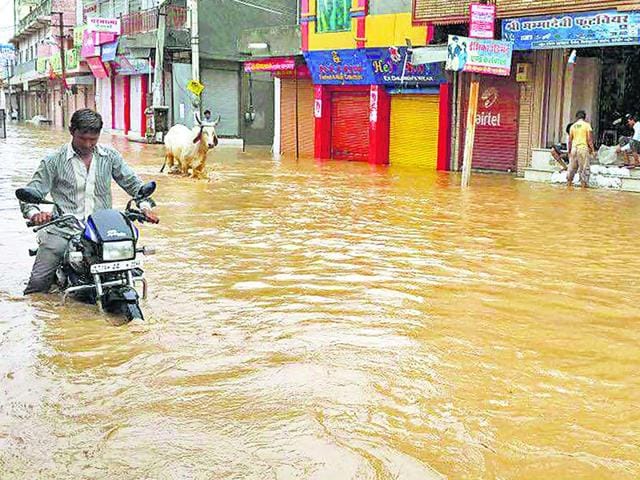 A-motorcyclist-negotiates-his-way-through-a-flooded-street-in-Jalore-on-Tuesday-HT-Photo