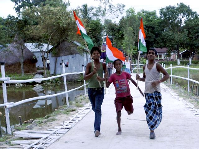 Children wave the Indian flag to celebrate the exchange of enclaves between India and Bangladesh. The exchange of 162 enclaves is taking place on July 31, 2015, marking the start of implementation of their landmark land boundary agreement. (Photo credit: Subhendu Ghosh) Children wave the Indian flag to celebrate the exchange of enclaves between India and Bangladesh. The exchange of 162 enclaves is taking place on July 31, 2015, marking the start of implementation of their landmark land boundary agreement. (Photo credit: Subhendu Ghosh)