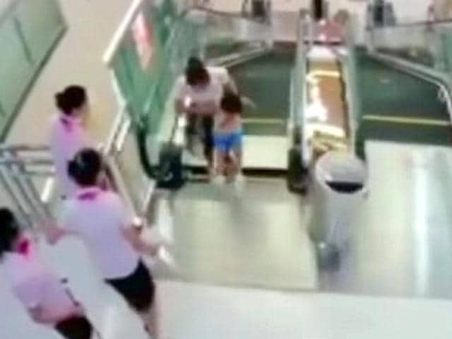 An-image-from-CCTV-camera-showing-Xiang-Liujuan-and-her-son-as-a-panel-at-the-top-of-the-escalator-gave-way-Reuters An-image-from-CCTV-camera-showing-Xiang-Liujuan-and-her-son-as-a-panel-at-the-top-of-the-escalator-gave-way-Reuters