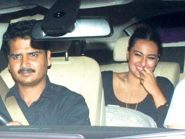 Sonakshi Sinha giggles in her car outside Arpita Khan's house. (Shakti Yadav/HT)