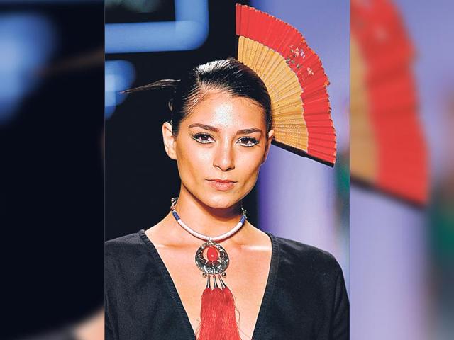Add a colourful headgear to your ensemble to stand out in a crowd. A model wears a creation by Studio F brand at the Colombiamoda fashion event.