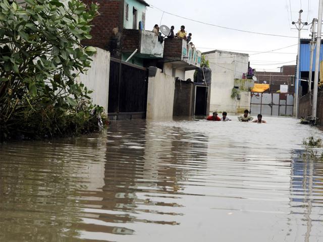Rainwater submerged houses in Indore's New Bajrangpura on Wednesday. People had to climb upstairs and stay put till the water receded. (Arun Mondhe/HT)