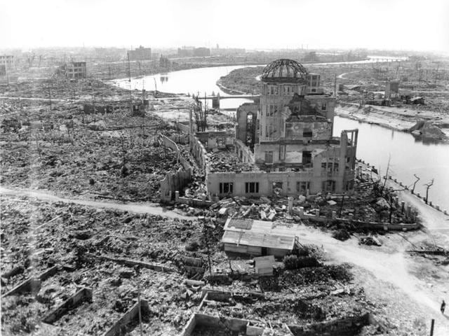 In this Sept 8, 1945 file photo, an allied correspondent stands in the rubble in front of the shell of a building that once was a exhibition center and government office in Hiroshima, Japan, a month after the first atomic bomb ever used in warfare was dropped by the US on Aug. 6, 1945. (AP Photo/Stanley Troutman, File) In this Sept 8, 1945 file photo, an allied correspondent stands in the rubble in front of the shell of a building that once was a exhibition center and government office in Hiroshima, Japan, a month after the first atomic bomb ever used in warfare was dropped by the US on Aug. 6, 1945. (AP Photo/Stanley Troutman, File)