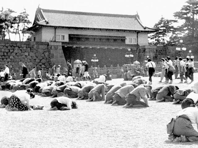 In this Aug 15, 1945 photo, Japanese people kneel in front of the Imperial Palace in Tokyo as Emperor Hirohito announced on radio that Japan was defeated in the World War II.(Kyodo New via AP) In this Aug 15, 1945 photo, Japanese people kneel in front of the Imperial Palace in Tokyo as Emperor Hirohito announced on radio that Japan was defeated in the World War II.(Kyodo New via AP)