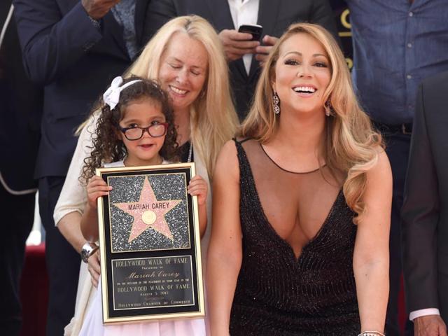 Mariah Carey strikes poses with Monroe Cannon during the ceremony at the Hollywood Walk of Fame ceremony in Los Angeles. (AP)