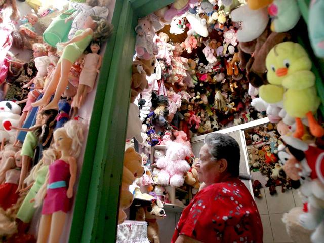 Rojas combs her hair in a bathroom of her home decorated with dolls. (Reuters Photo/ Juan Carlos Ulate)