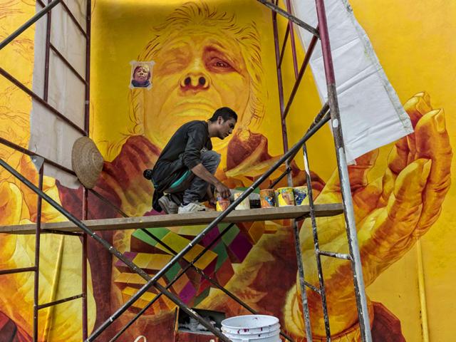 An artist nicknamed "Trejo" paints a mural honouring the wisdom of elderlies at one of the streets of the hill 'Las Palmitas' in Pachuca, Hidalgo state, Mexico. (AFP Photo)