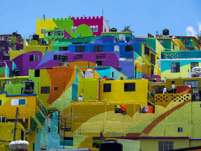 The town, earlier known as a battleground for gangs has been transformed into a giant mural. Rival gangs came together to facilitate the initiative funded by the Mexican government. (AFP Photo)