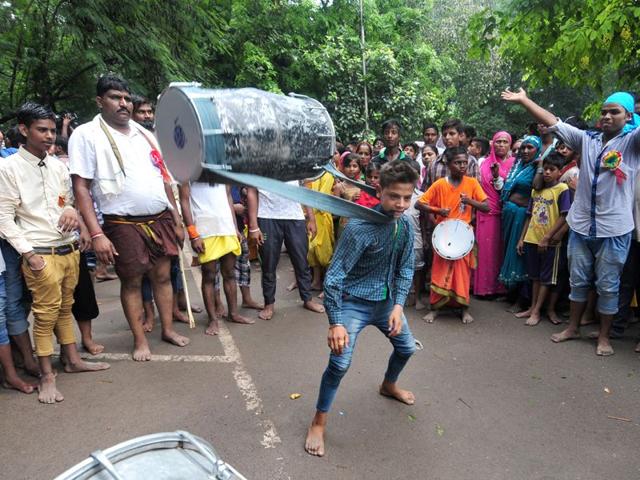 A kid showcasing his skills during the religious procession dedicated to the Hindu goddess Shitla Mata at sukhna lake in Chandigarh. (Photo by Ravi Kumar/Hindustan Times)