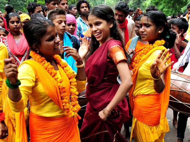 Girls dancing during the religious procession dedicated to the Hindu goddess Shitla Mata at sukhna lake in Chandigarh. (Photo by Ravi Kumar/Hindustan Times)