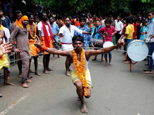 Devotees dance with pierced faces during the religious procession dedicated to the Hindu goddess Shitla Mata at sukhna lake in Chandigarh. (Photo by Ravi Kumar/Hindustan Times)