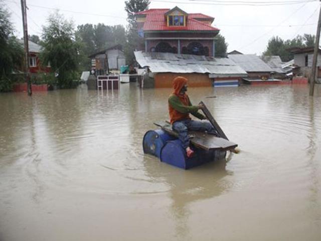 A man sailing on makeshift plank in flooded waters of Srinagar. HT File Photo A man sailing on makeshift plank in flooded waters of Srinagar. HT File Photo