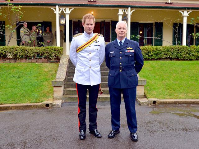 Prince Harry (L) stands with the chief of the Australian Defence Force Air Chief Marshal Mark Binskin as they pose for a photograph after he arrived at the Duntroon Royal Military College in Canberra. (Reuters)
