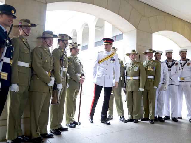 Prince Harry (C) stands with members of the 'Catafalque Party' during a visit to the Australian War Memorial in Canberra April 6, 2015. (REUTERS/Lukas Coch/Pool)