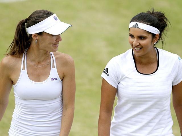 Martina Hingis of Switzerland, left, and Sania Mirza of India talk between points during their women's doubles quarter-final match of the 2015 Wimbledon Championships against Casey Dellacqua of Australia and Yaroslava Shvedova of Kazakhstan at The All England Lawn Tennis and Croquet Club in London, on July 8, 2015. Mirza-Hingis won 7-5, 6-3. (AP Photo) Martina Hingis of Switzerland, left, and Sania Mirza of India talk between points during their women's doubles quarter-final match of the 2015 Wimbledon Championships against Casey Dellacqua of Australia and Yaroslava Shvedova of Kazakhstan at The All England Lawn Tennis and Croquet Club in London, on July 8, 2015. Mirza-Hingis won 7-5, 6-3. (AP Photo)