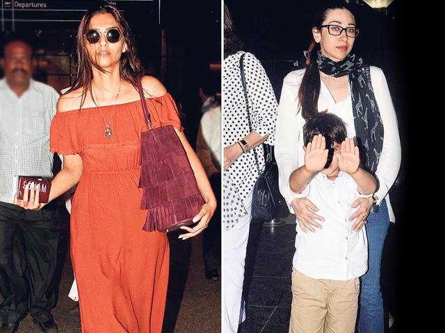 Sonam Kapoor and Karisma Kapoor spotted at the airport. Karisma was seen with her son who was trying to shield his face from the media. (HT photo)