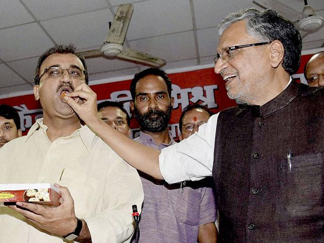 BJP senior leader Sushil Kumar Modi offers sweet to state party president Mangal Pandey and opposition leader Nand Kishor Yadav after National Democratic Alliance's victory in the Bihar Legislative Council elections in Patna on Friday. (PTI Photo) BJP senior leader Sushil Kumar Modi offers sweet to state party president Mangal Pandey and opposition leader Nand Kishor Yadav after National Democratic Alliance's victory in the Bihar Legislative Council elections in Patna on Friday. (PTI Photo)