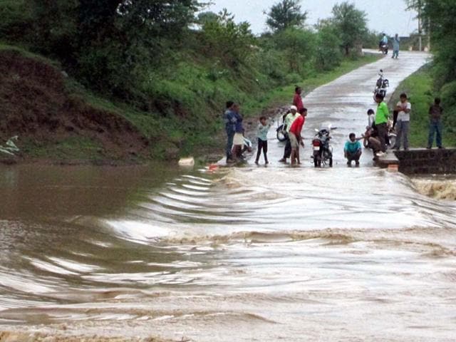 In Begamganj tehsil of Raisen district, about a dozen villages remained cut off as local rivulet Semri was on spate on Saturday following heavy rains. (HT)
