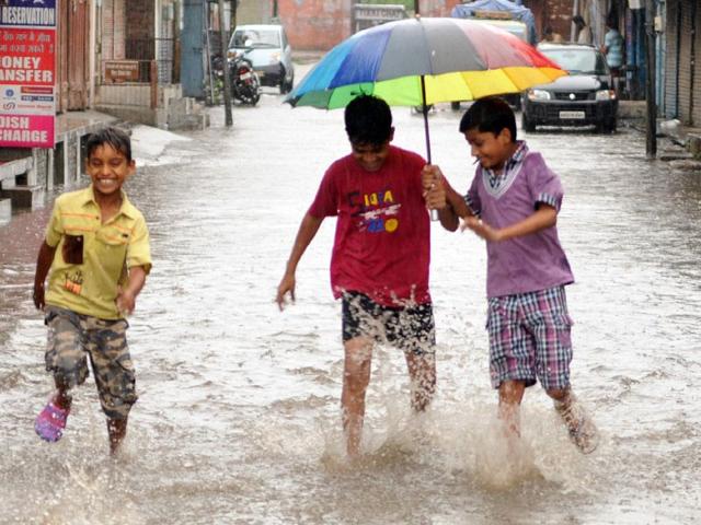 Children enjoying in rain in Patiala on Sunday. Bharat Bhushan/HT