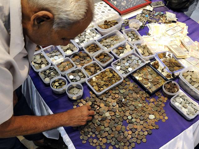 A man having a look at the collection of coins exhibited at the ongoing 3rd Coin Currency and Philately Festival in Indore. (Shankar Mourya/HT)
