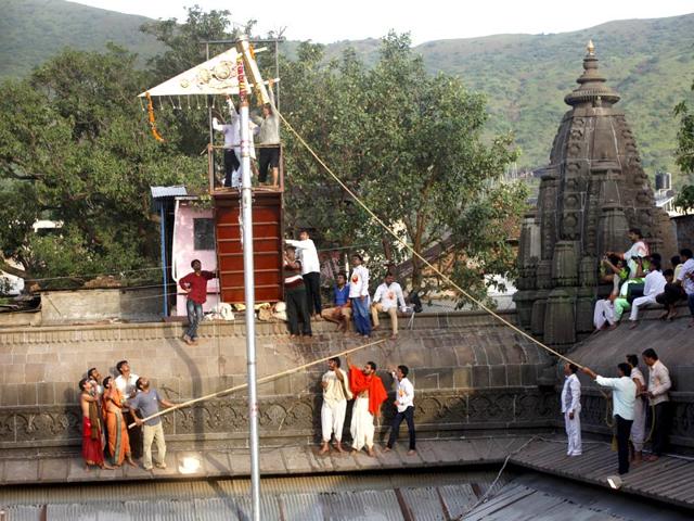 The flag is being hoisted to mark the beginning of Simhastha Kumbh Mela at Nashik. (Arijit Sen/HT photo) 