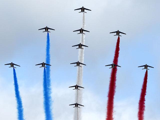At the annual military parade Alpha Jets of the French Air Force, La Patrouille de France, release trails of blue, white and red smoke in the colours of the French national flag fly over the Champs Elysees. AFP Photo/ Alain Jocard) At the annual military parade Alpha Jets of the French Air Force, La Patrouille de France, release trails of blue, white and red smoke in the colours of the French national flag fly over the Champs Elysees. AFP Photo/ Alain Jocard)