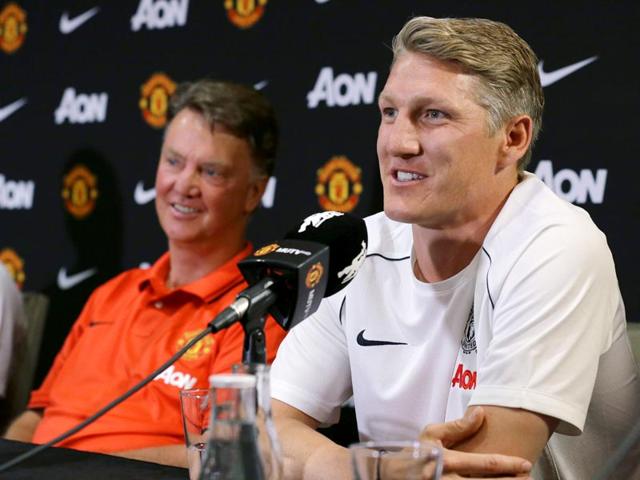 Manchester United manager Louis van Gaal, left, listens as Bastian Schweinsteiger talks to reporters after being introduced as a new signing with the club, on July 15, 2015, in Bellevue, Washington. Manchester United is in Seattle for an international friendly soccer match against Mexico's Club America to be played on July 17. (AP Photo) Manchester United manager Louis van Gaal, left, listens as Bastian Schweinsteiger talks to reporters after being introduced as a new signing with the club, on July 15, 2015, in Bellevue, Washington. Manchester United is in Seattle for an international friendly soccer match against Mexico's Club America to be played on July 17. (AP Photo)