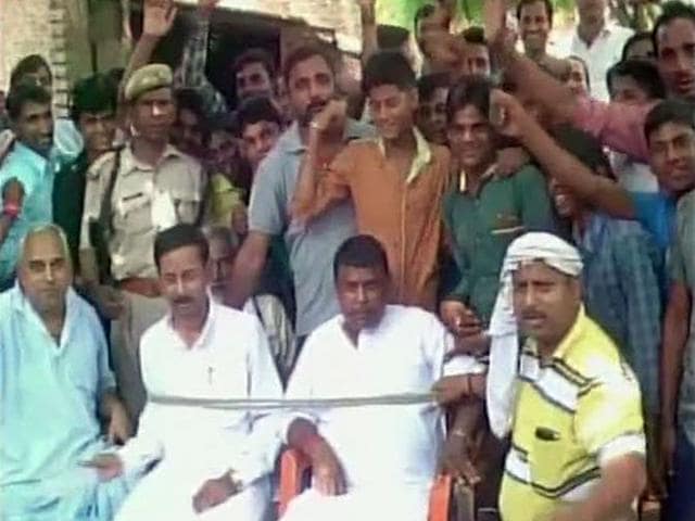 Villagers of Chandauli village in Uttar Pradesh held BSP MLA Babban Singh Chauhan and a local councillor over power cut issue on Sunday. (ANI Photo)