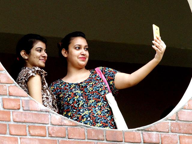 Students taking Selfie on the first day of college at Ram Lal Anand College in north campus in New Delhi, India. (HT Photo/Arun Sharma)