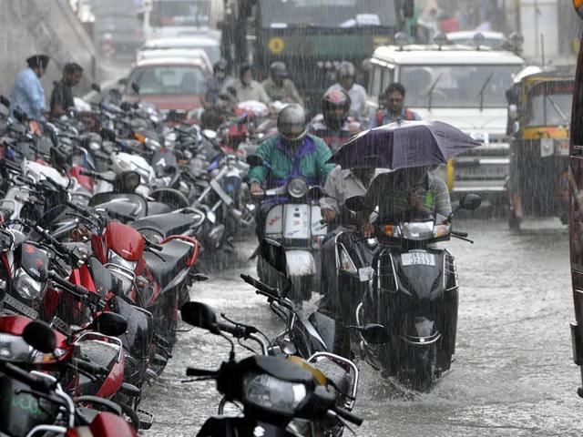 Commuters struggling to cross a waterlogged area in Jammu on Tuesday. Nitin Kanotra/HT Commuters struggling to cross a waterlogged area in Jammu on Tuesday. Nitin Kanotra/HT