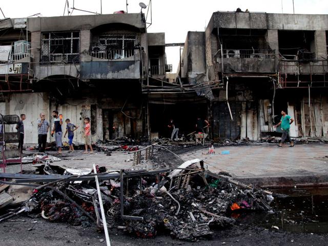 Civilians inspect damages on Wednesday in the eastern neighborhood of New Baghdad after car bomb detonated in front of a busy clothing store on Tuesday killed and injured civilians. (AP Photo/ Khalid Mohammed) Civilians inspect damages on Wednesday in the eastern neighborhood of New Baghdad after car bomb detonated in front of a busy clothing store on Tuesday killed and injured civilians. (AP Photo/ Khalid Mohammed)