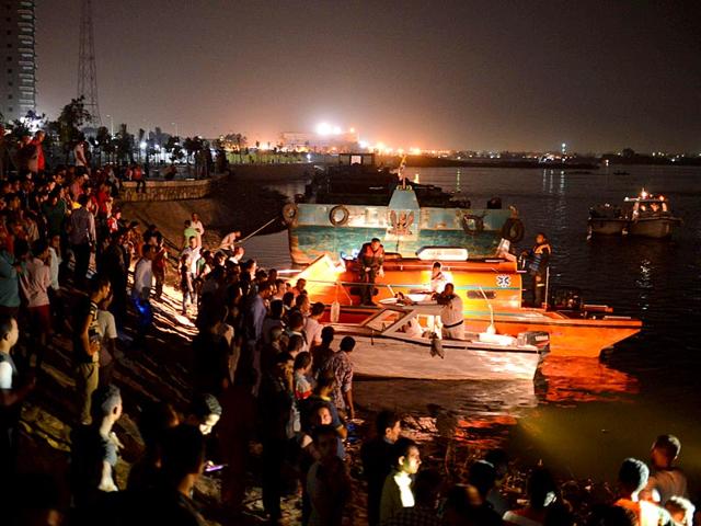 Police boats search for victims of a ferry boat accident on the River Nile in the Warraq area of Giza. At least 15 people drowned when a small boat collided with a barge and capsized on the Nile River near Cairo on Wednesday night, Egypt's interior ministry said (REUTERS Photo)